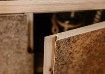 A close-up shot of a kitchen door front with a shadow gap handle. The substrate is birch ply but an oak lip has been added. The front is made from Husk Kava surface.