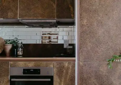 A close-up shot of a kitchen door front with a shadow gap handle. The substrate is birch ply but an oak lip has been added. The front is made from Husk Kava surface.