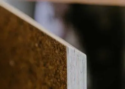 A close-up shot of a kitchen door front with a shadow gap handle. The substrate is birch ply but an oak lip has been added. The front is made from Husk Kava surface.